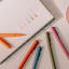 Papier High Energy Fineliner Pens, Pack of 5 on the table with a note book