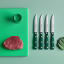 Wusthof Classic Colours Rosemary Steak Knives, Set of 4 with a raw piece of steak