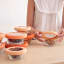 Food Huggers Adjustable Silicone & Glass Lids, Set of 3 - Terracotta on bowls