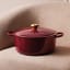 Le Creuset Signature 3.3 Litre Round Cast Iron Casserole, 22cm - Rhone on a couch