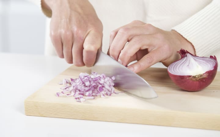 chopping onion with a chefs knife