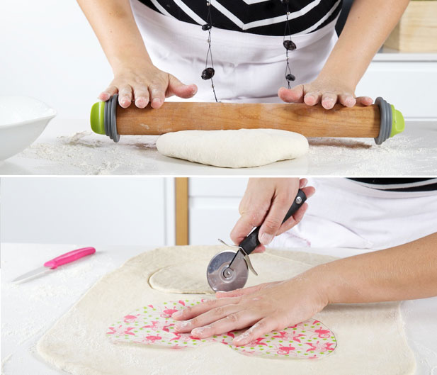 Cutting the heart shaped pizza from a stencil