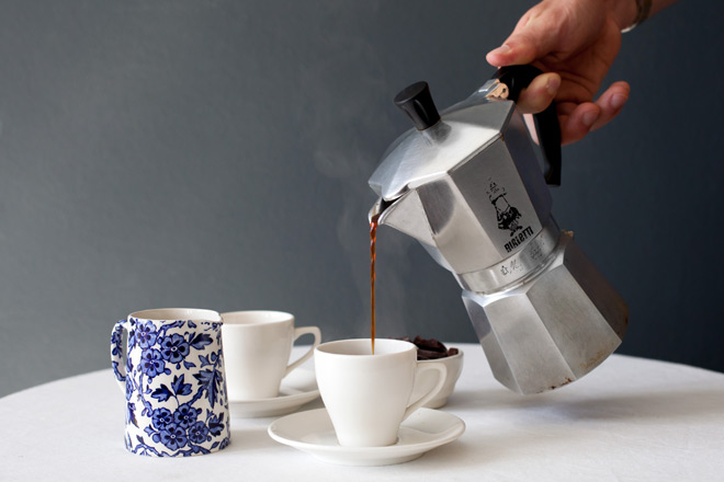 pouring the stovetop coffee out of the moka pot