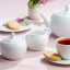 Noritake Arctic White Creamer Jug with a teapot, cup of tea and side plate with cookies