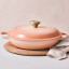 Le Creuset Peche Signature 3.5 Litre Shallow Casserole, 30cm on the table