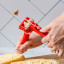 Dreamfarm Garject Lite Garlic Press - Red garlic being pressed