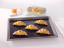 NoStik Reusable Baking Liner, on tray with croissants