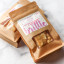 The Counter Salted Macadamia & Rosemary Brittle, 120g on the table