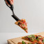 Dreamfarm Scizza Pizza Cutter & Lifter - Black with a slice of pizza