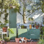 Popstrukt Sugar Cube Media Unit - Dark Olive in the garden area