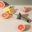 Eva Solo Green Tool Citrus Press on the kitchen counter with citrus fruits