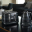 DeLonghi Avvolta Class 4-Slice Toaster, 1800W - Black with a kettle on the table