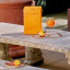 Fieldbar Drinks Cooler Box, 10L - Orchard Orange  on table with drinks