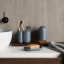 Umbra Touch Toothbrush Holder - Slate Blue  next to a basin