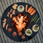 Hoefats Plancha for Fire Bowl in use