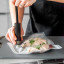 MasterClass Food Vacuum Sealer with 4 Reusable Polyethylene Food Bags in use