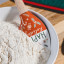 Tovolo Spatulart Spatula - Let There Be Peas in a bowl of flour