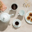 Noritake Arctic White Large Porcelain Mugs with coffee next to a cup of tea, a teapot and plate of mini pecan pies 
