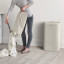 Joseph Joseph Tota 60L Laundry Separation Basket - Ecru removing laundry from the basket