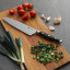 Sagenwolf Performance Chef's Knife, 21cm on a wooden board with sliced chives 