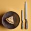 Wusthof Classic Sausage Knife, 14cm - Velvet Oyster on the table with a bowl