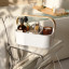 Umbra Bellwood Stackable Bin - Small on a stool in the bathroom next to the bath with bath products in it