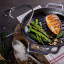 Victoria Seasoned Round Grill Cast Iron Skillet, 26cm on the table with food