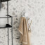 Umbra Flex Adhesive Double Hook - White against wall with towel