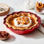 Le Creuset Stoneware Pie Dish, 23cm - Cerise with pie on the table
