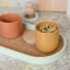 KitchenCraft Idilica Oval Tray with Cork Veneer Base on the counter with canisters