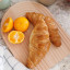 KitchenCraft Idilica Reversible Beech Wood Chopping and Serving Board with croissants