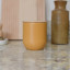 KitchenCraft Idilica Metal Storage Canister, 450ml - Yellow on the kitchen counter