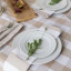 Linen House Revana Stone Check Tablecloth with plates and napkins