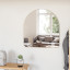 Umbra Hubba Arched Mirror - Brass In A Bedroom Setting 