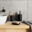 Umbra Junip Pump Soap Dispenser - Black with a soap dish next to the basin