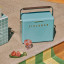 Fieldbar Gin Trunk - Bazaruto Blue outside next to a cocktail