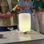 Kooduu Atmos Brass All-In-One Wine Cooler Speaker & Lamp on the table