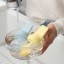 Zuutii Oil Dispenser with Brush, 130ml - Creamy Yellow in a bowl of water