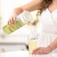 Zuutii Infusion Pitcher, 1.2L - Light Cream with a glass