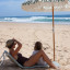 Sunnylife Reclining Beach Chair - The Vacay Olive on beach sand