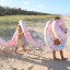 Sunnylife Giant Inflatable Noodle Snake - Tie Dye at the beach