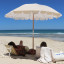 Sunnylife Beach Umbrella - Mango Bay Golden Mustard Stripe at the beach