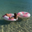 Sunnylife Tube Pool Ring - Bubblegum Pink floating in water