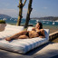 Sunnylife Luxe Lie-On Lounger Float - Lazy Days Blue Stripe on a patio