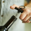 Gentlemens Hardware Mini Corkscrew Keychain on a wine bottle