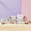 Le Creusetï¿½s Sorbet Collection displayed with a pastel-striped backdrop. The image features colorful packaging for the collection, stacked bowls, mugs, and a footed ice cream bowl with a spoon. The products are arranged on pastel blocks in shades of pink, yellow, and lavender.