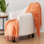 Linen House Coral Blossom Embrace Throw on a chair