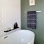 Joon Mila Slim Shower Shelf, 35cm on a wall next to the bathtub