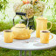 Le Creuset Chamomile Whistling Stovetop Kettle with Stainless Steel Knob, 1.6L on the table