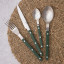 Nicolson Russell Louisiana Cutlery Set, 16-Piece - Dark Green on a table mat
